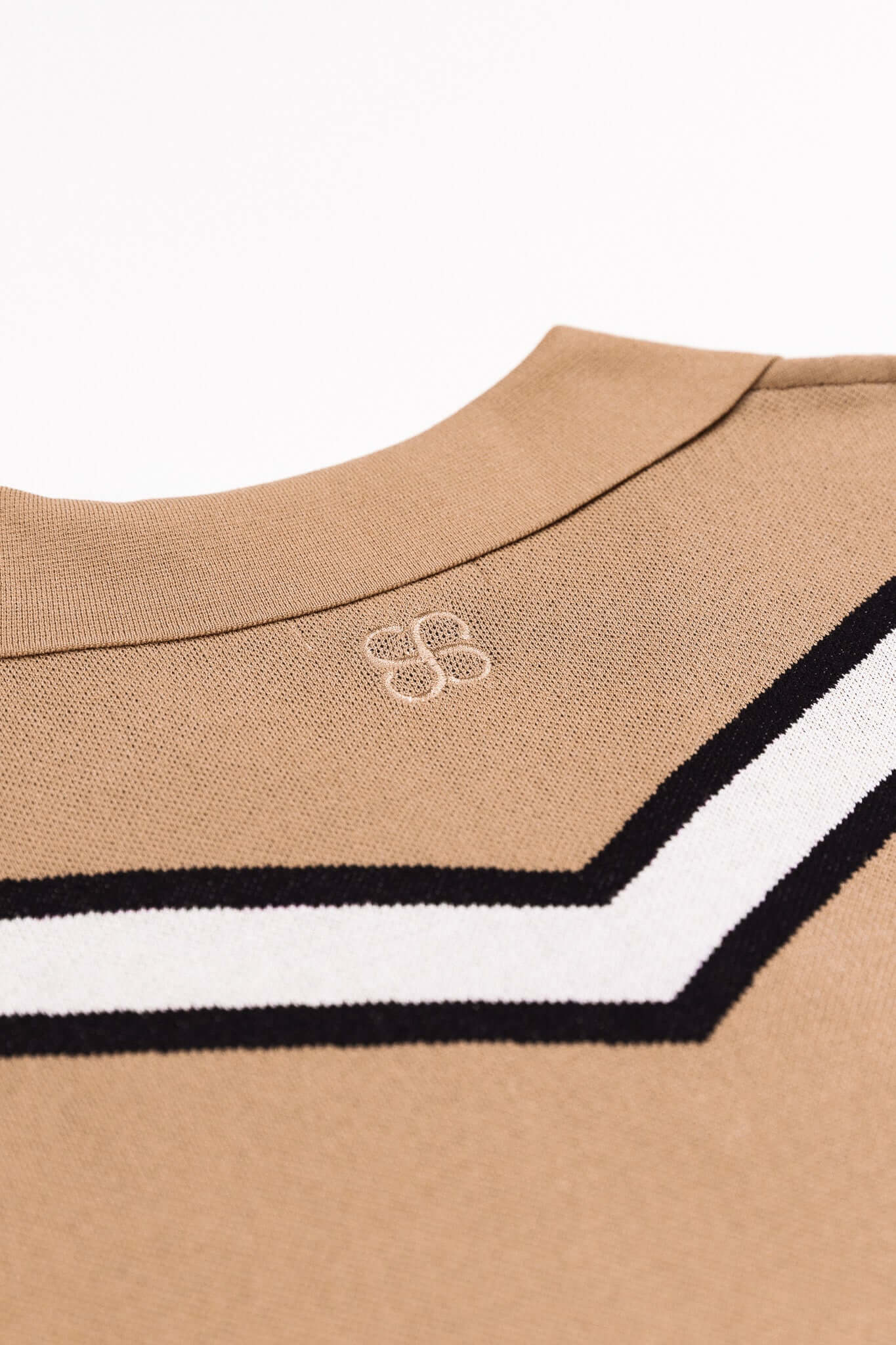 Chevron Zigzag Polo close-up of buttonless collar and bold chevron stripe in caramel colorway.