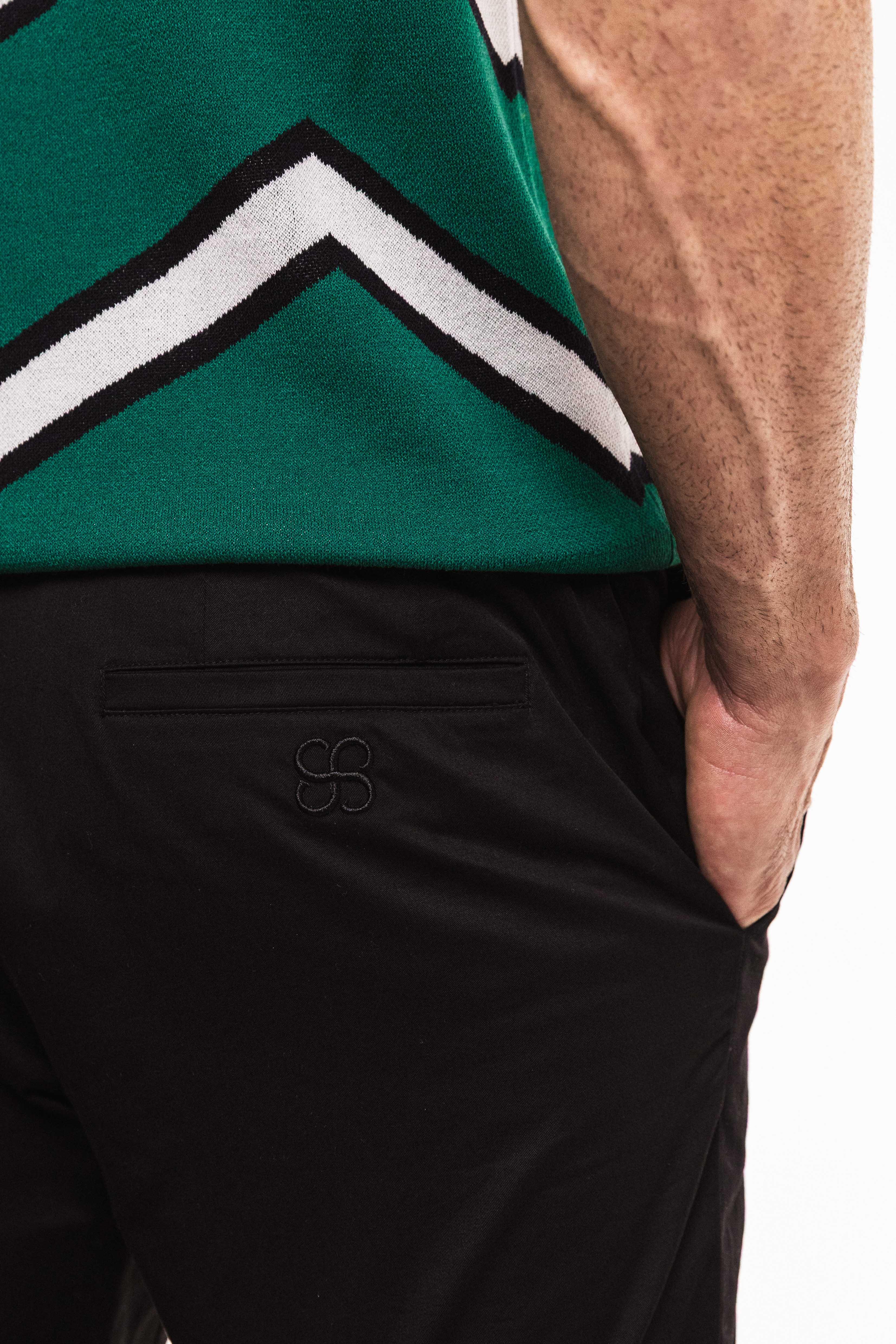 Close-up side view of a man wearing Classic Cotton Trouser, showcasing the stylish pocket and tailored fit.