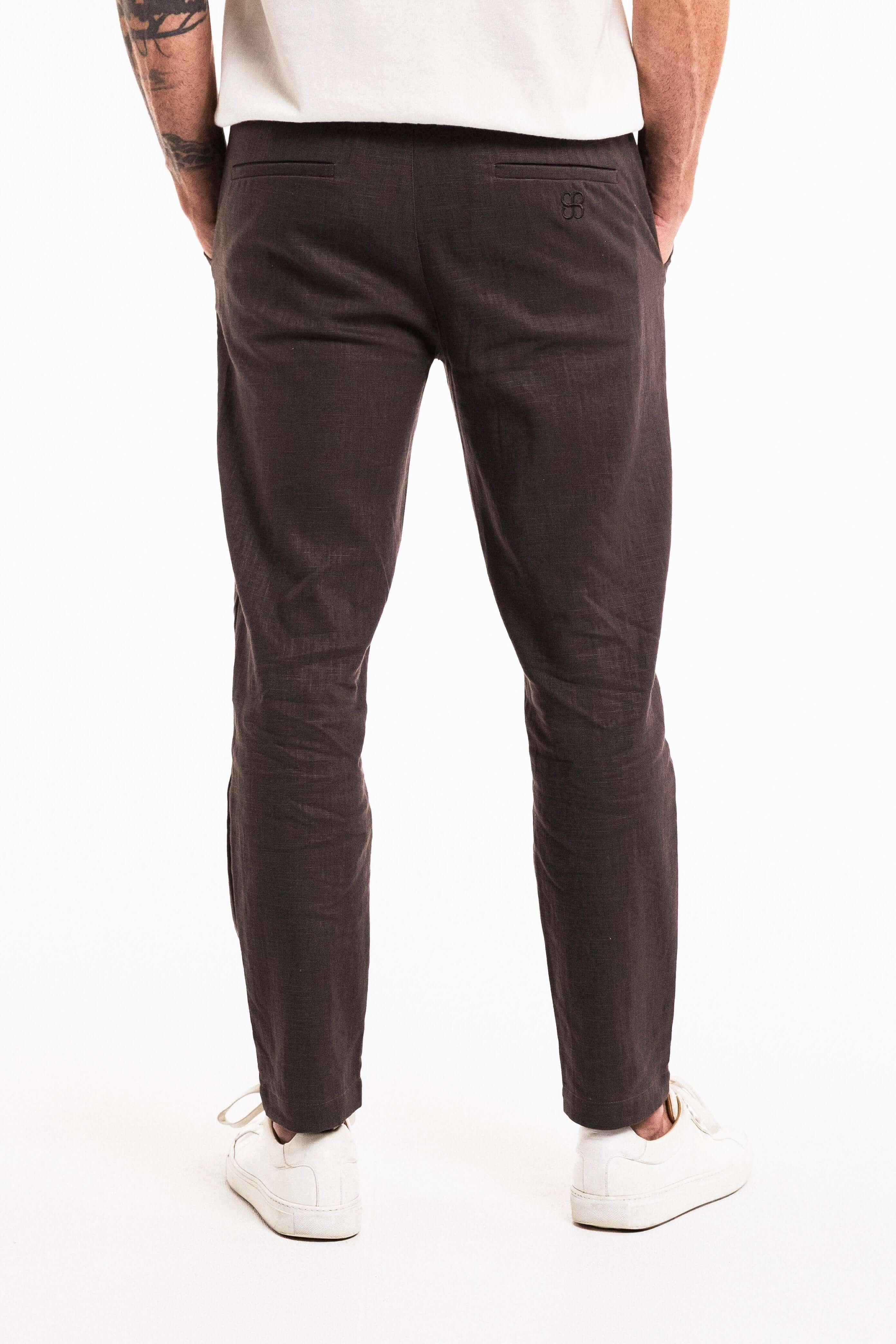 Back view of Tailored Lounge Linen Pant in Charcoal showcasing the elasticated waistband and straight-leg cut.