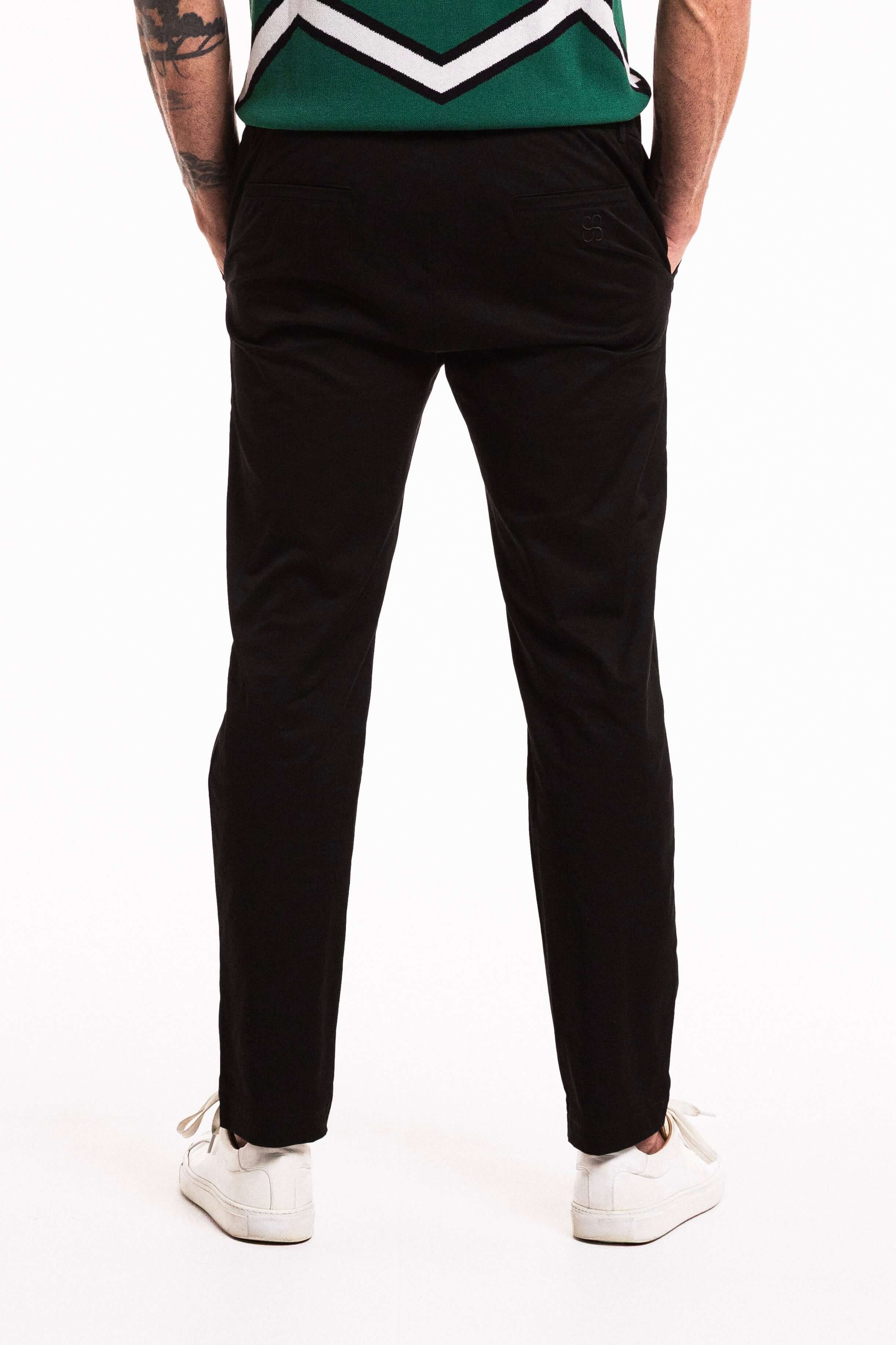 Classic Cotton Trouser in Obsidian, showcasing a tailored fit and straight-leg silhouette from the back.