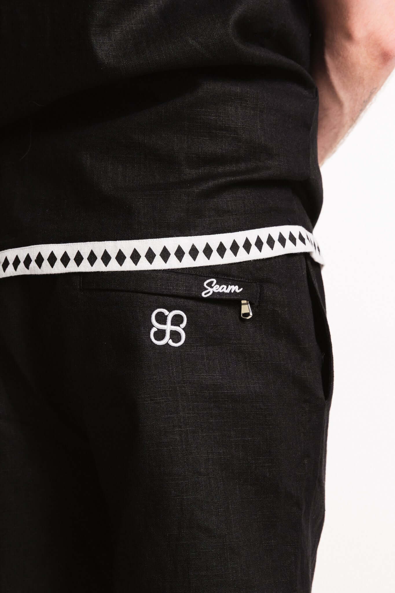 Diamond Trim Linen Shorts with contrasting woven hem and SEAM embroidery for stylish comfort.
