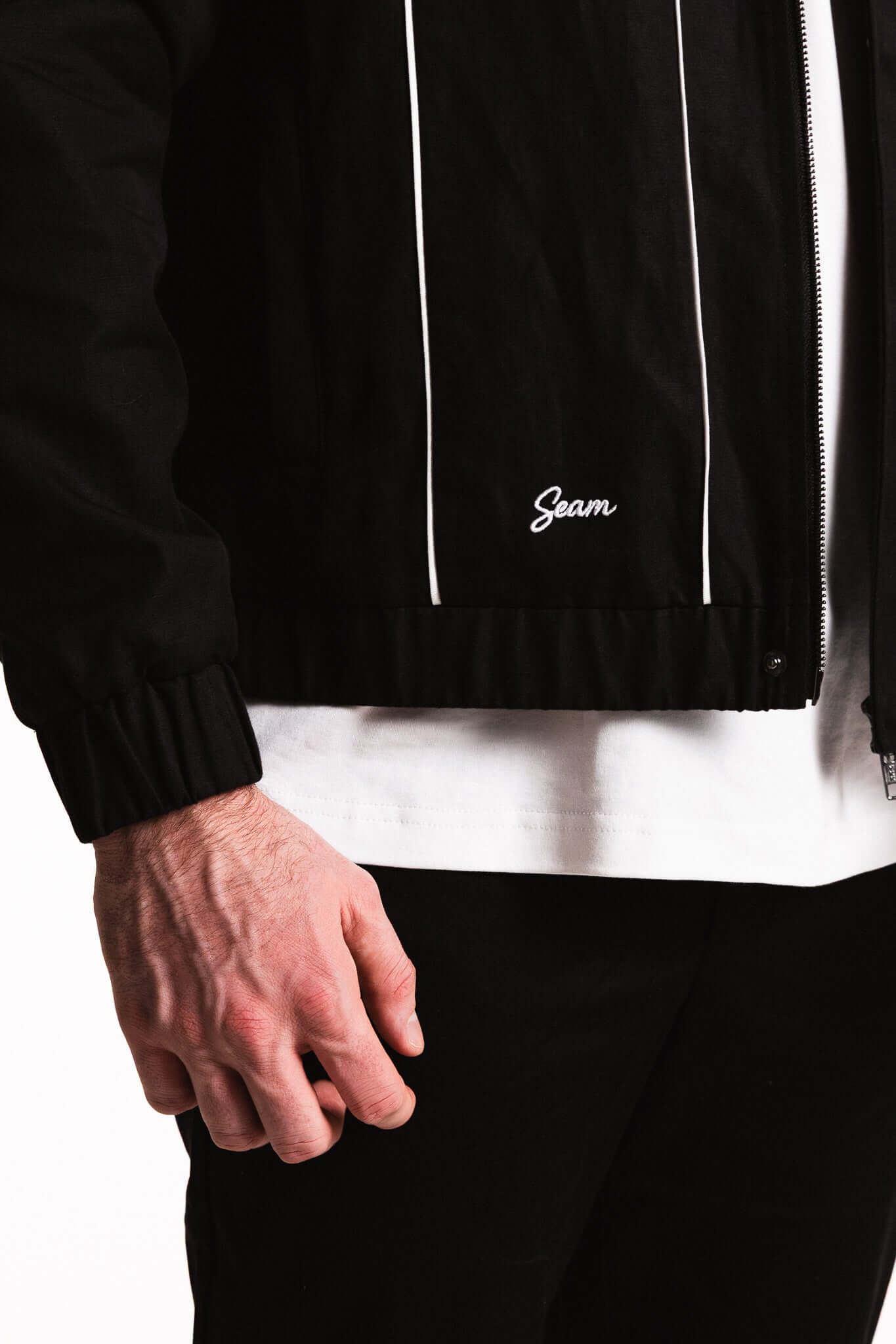 Cotton Contrast Jacket featuring a black cotton blend with white piping and elasticated cuffs for a modern look.
