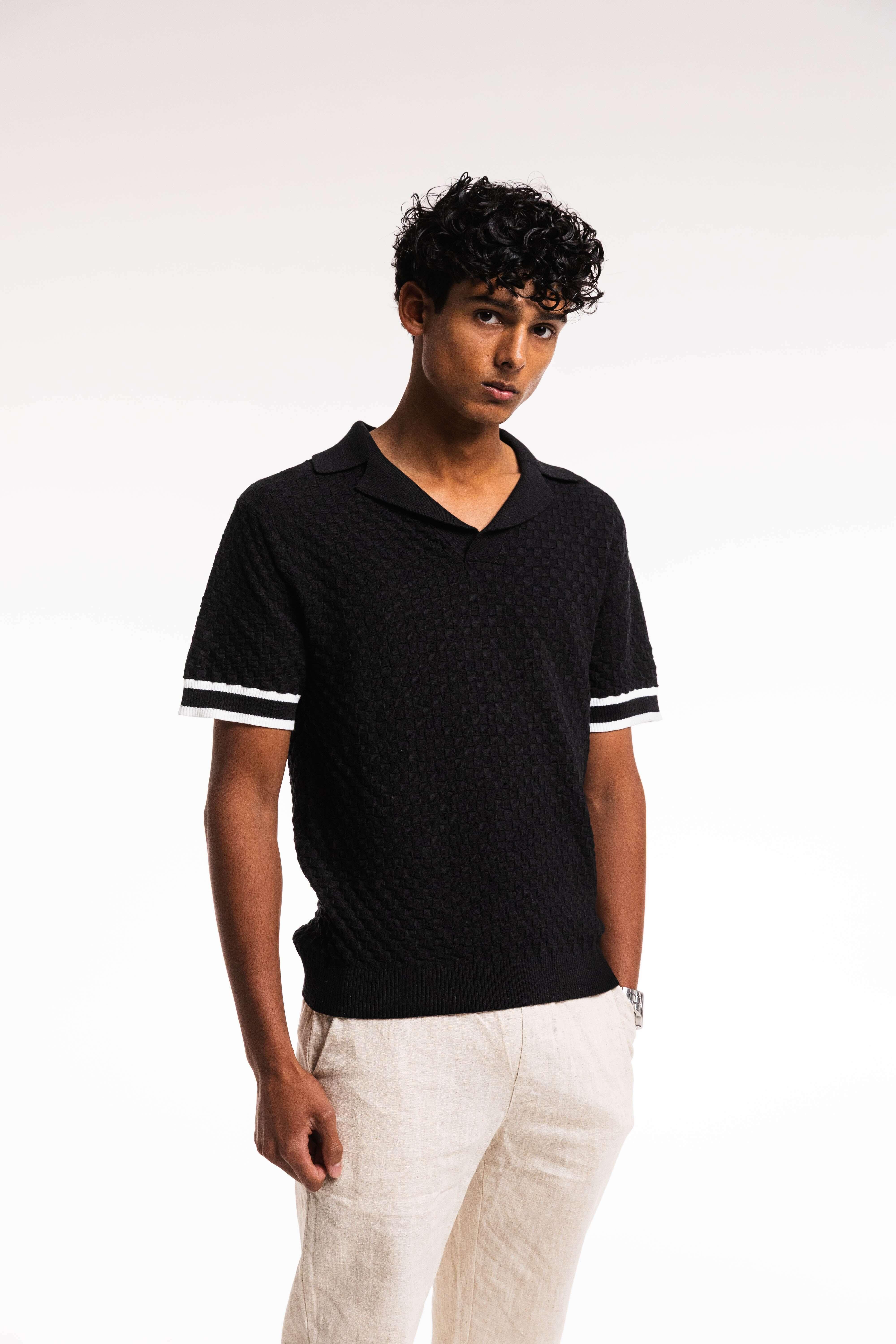 Model wearing Checkered Polo – black and cream knit front view close up