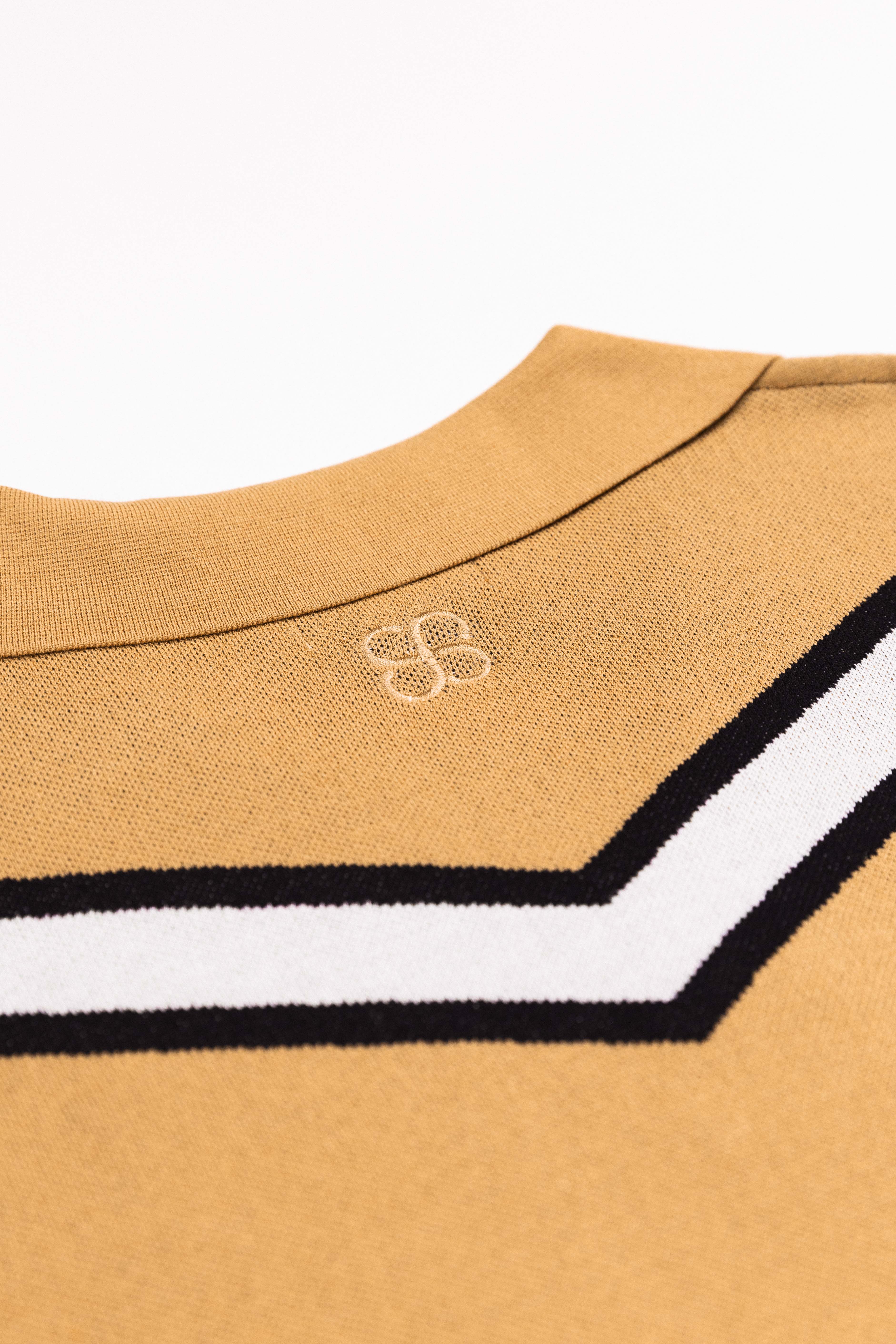 Close-up of chevron knit texture on Caramel Polo shirt fabric