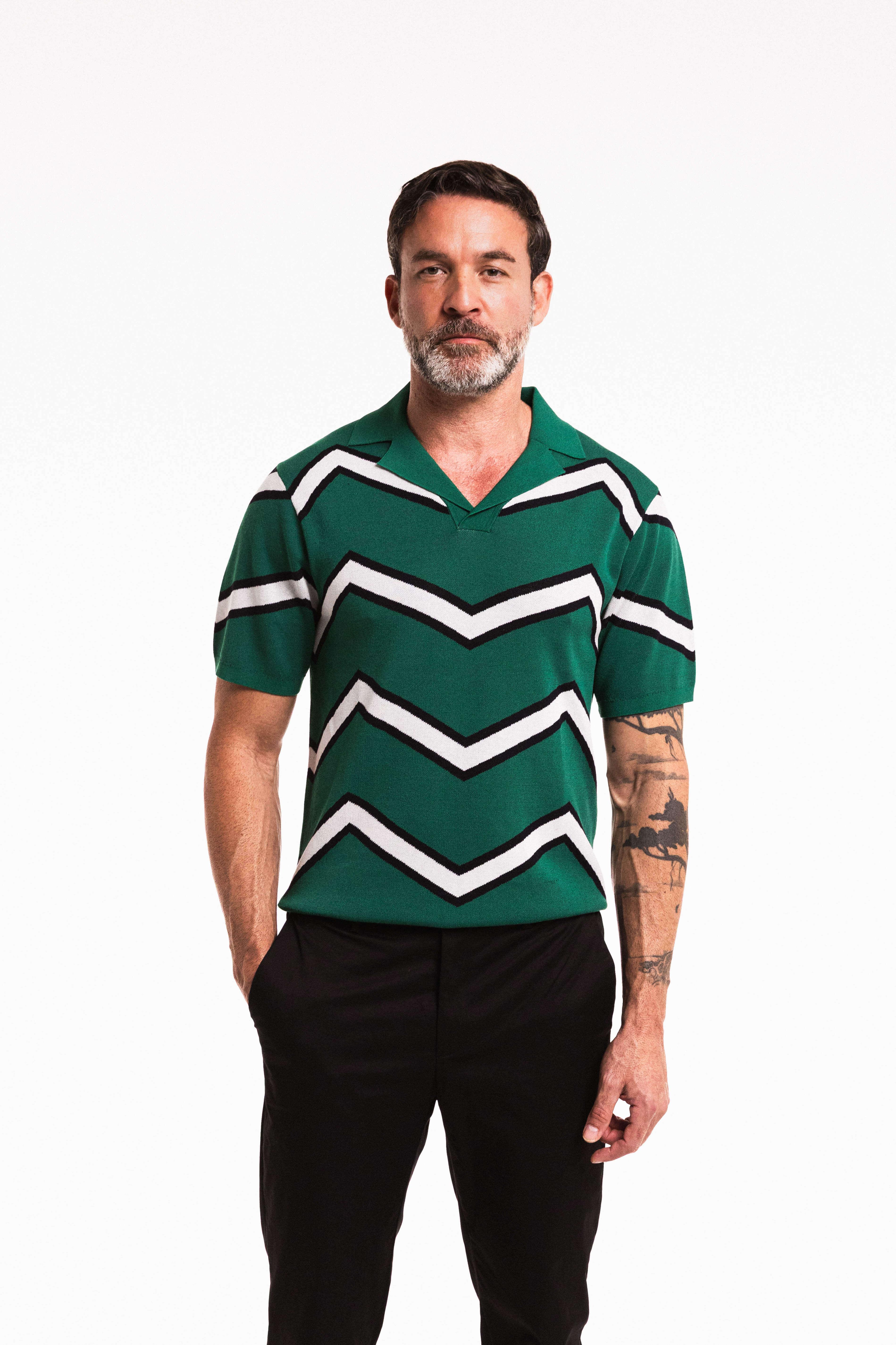 Model wearing Chevron Polo in Forest Green – close up front view standing