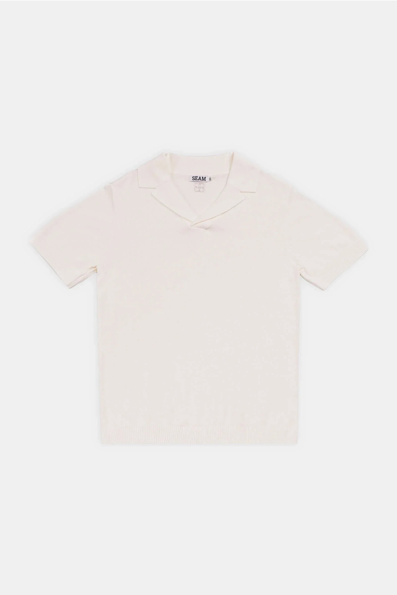 Classic Cotton Knit Polo in soft beige with a classic collar and short sleeves, offering a refined and relaxed aesthetic.