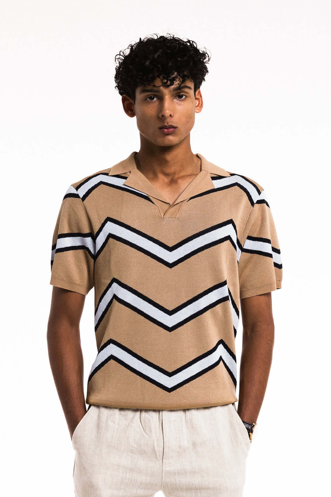 Chevron Zigzag Polo in Caramel featuring bold zigzag stripes, buttonless collar, and rib-knit cuffs for a stylish fit.