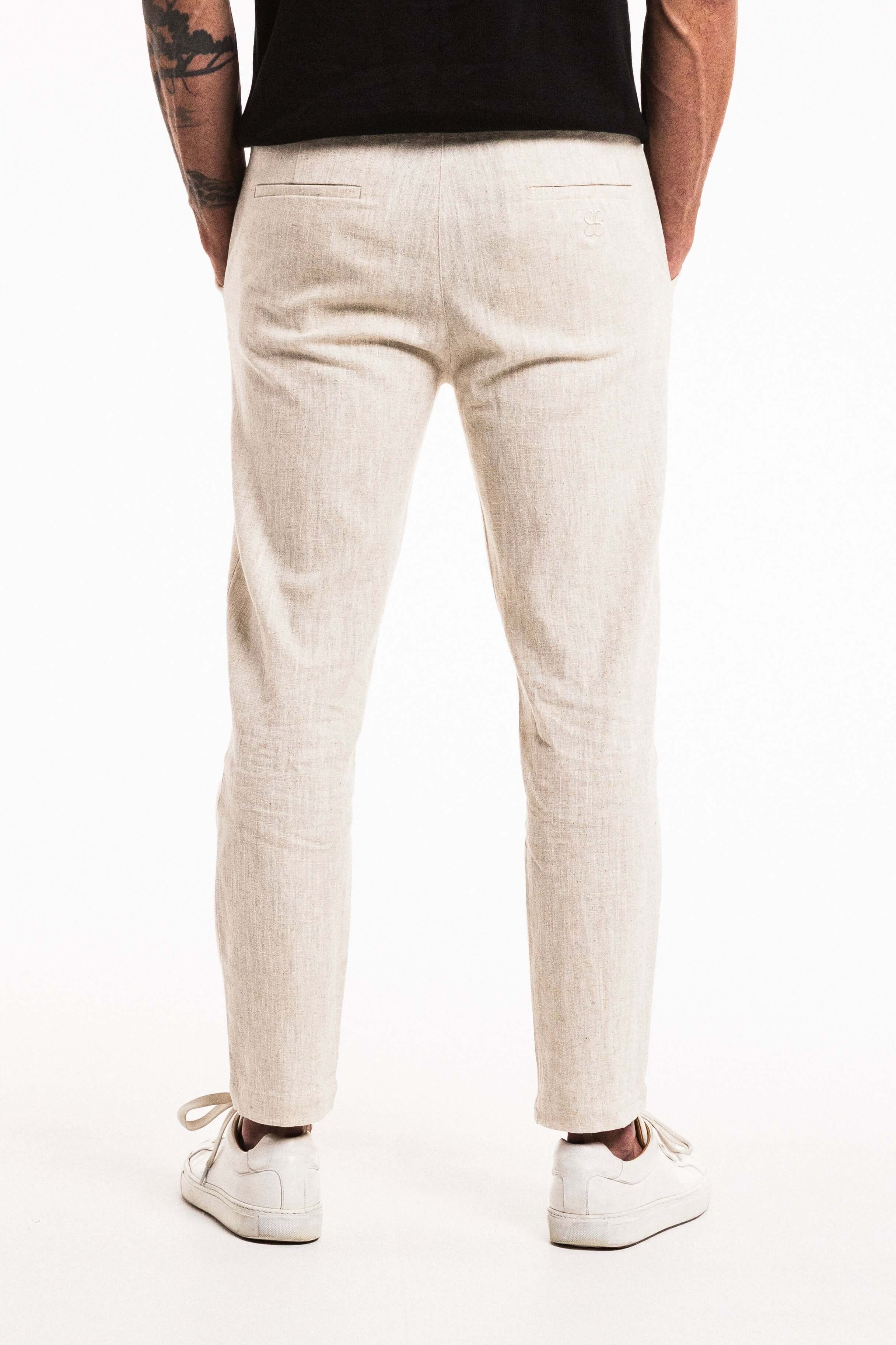 Lounge Linen Pant in Wheat showcasing the relaxed fit, elasticated waistband, and straight-leg style from the back.
