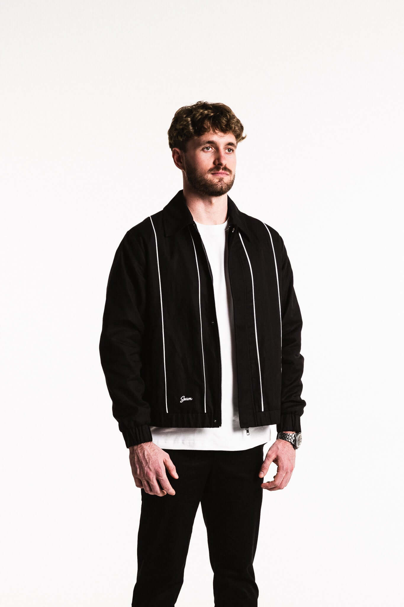 Man wearing a Cotton Contrast Jacket in Black with white piping, showcasing a modern silhouette and full cotton lining.