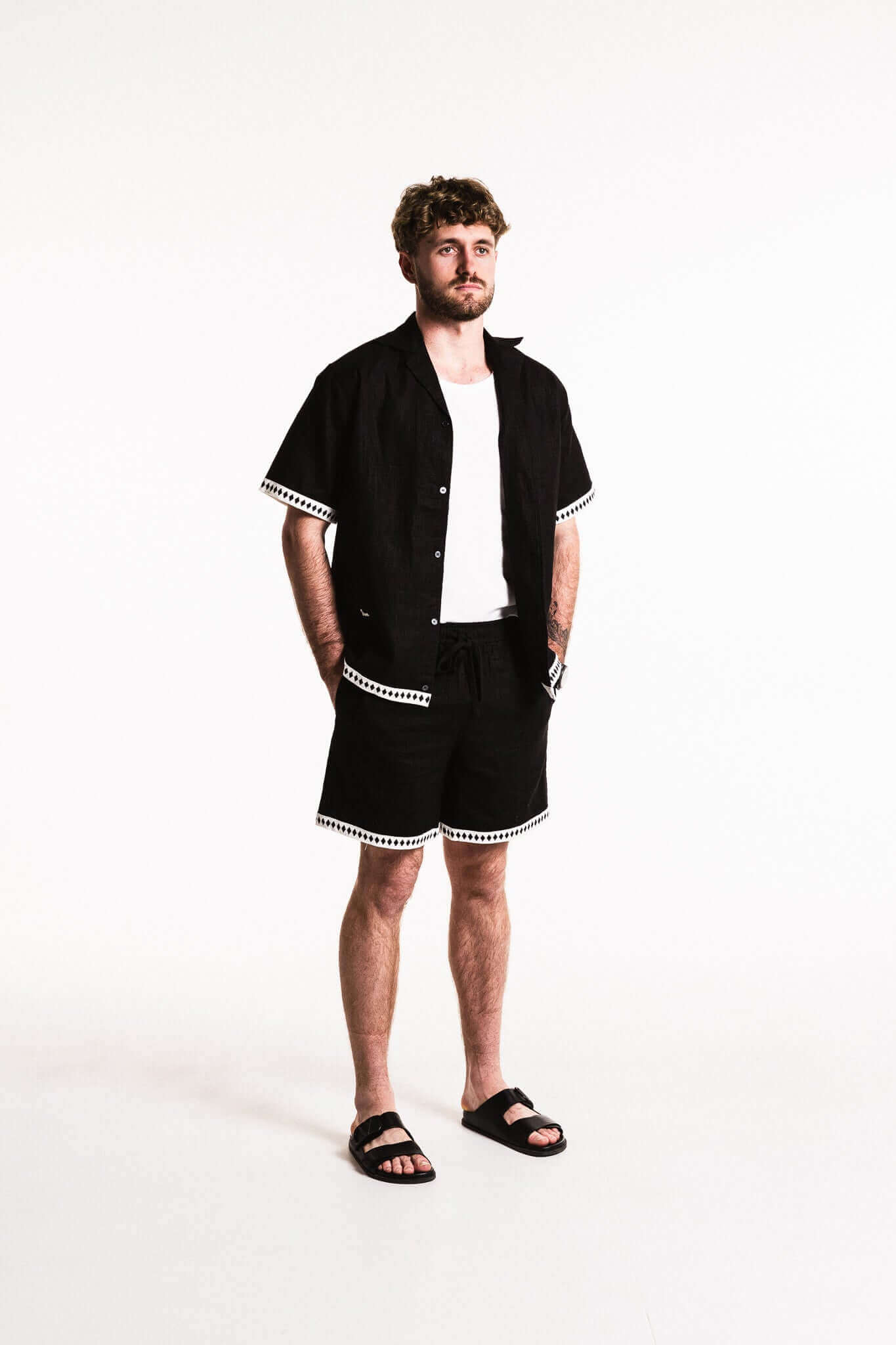 Man wearing a Diamond Trim Linen Shirt with contrast diamond trim, featuring a relaxed fit and camp collar.