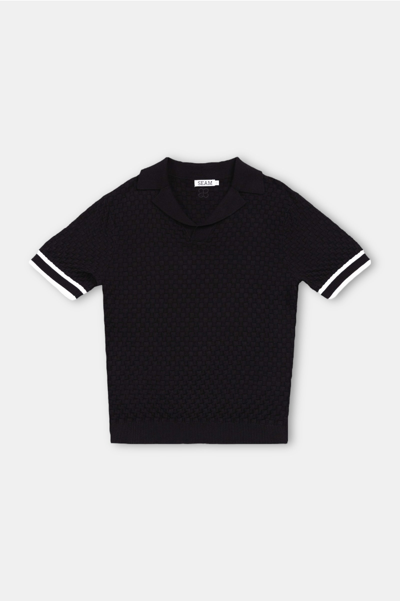 Checkered Polo – black and cream knit front view flat lay