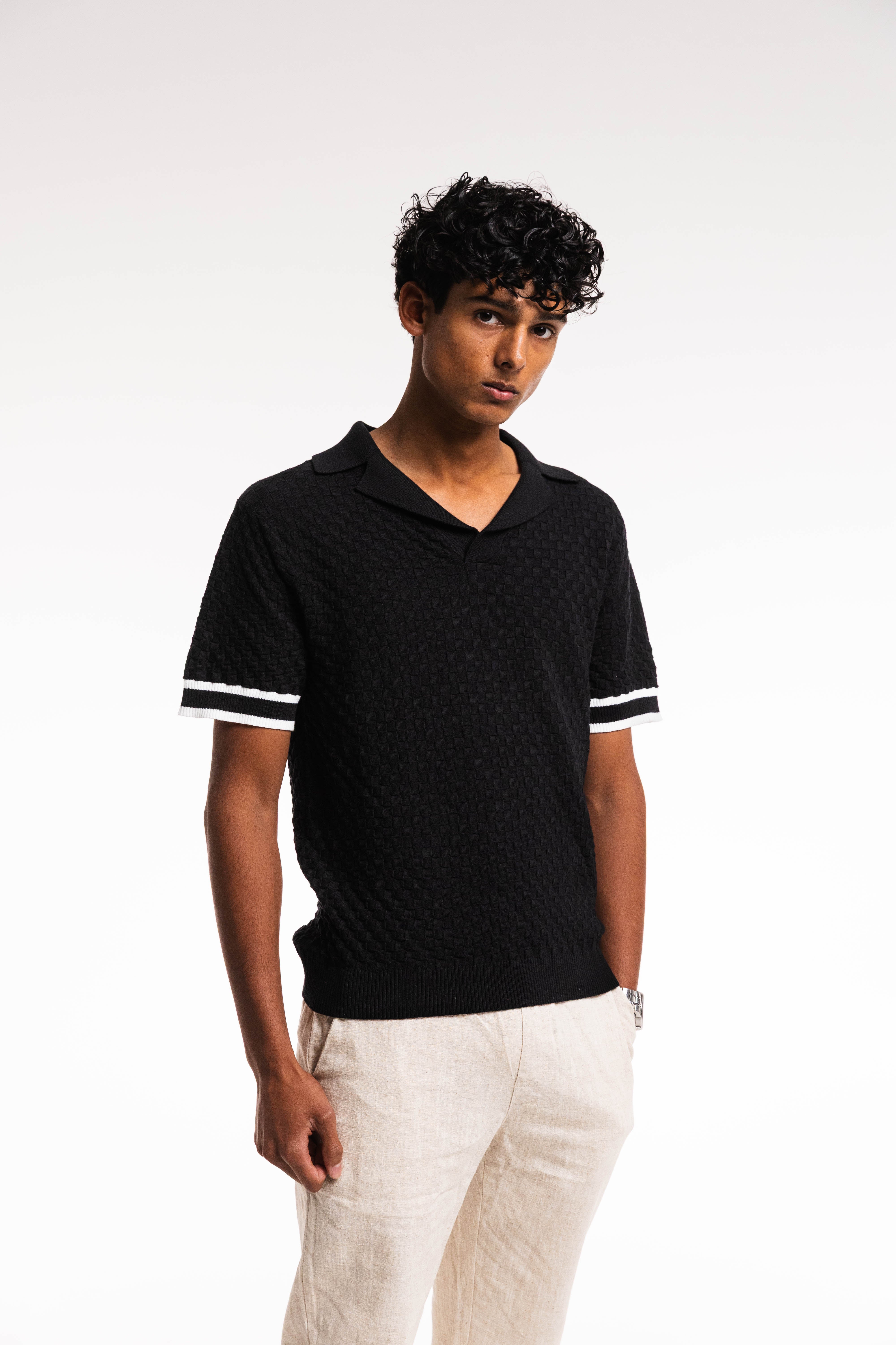 Model wearing Checkered Polo – black and cream knit front view close up