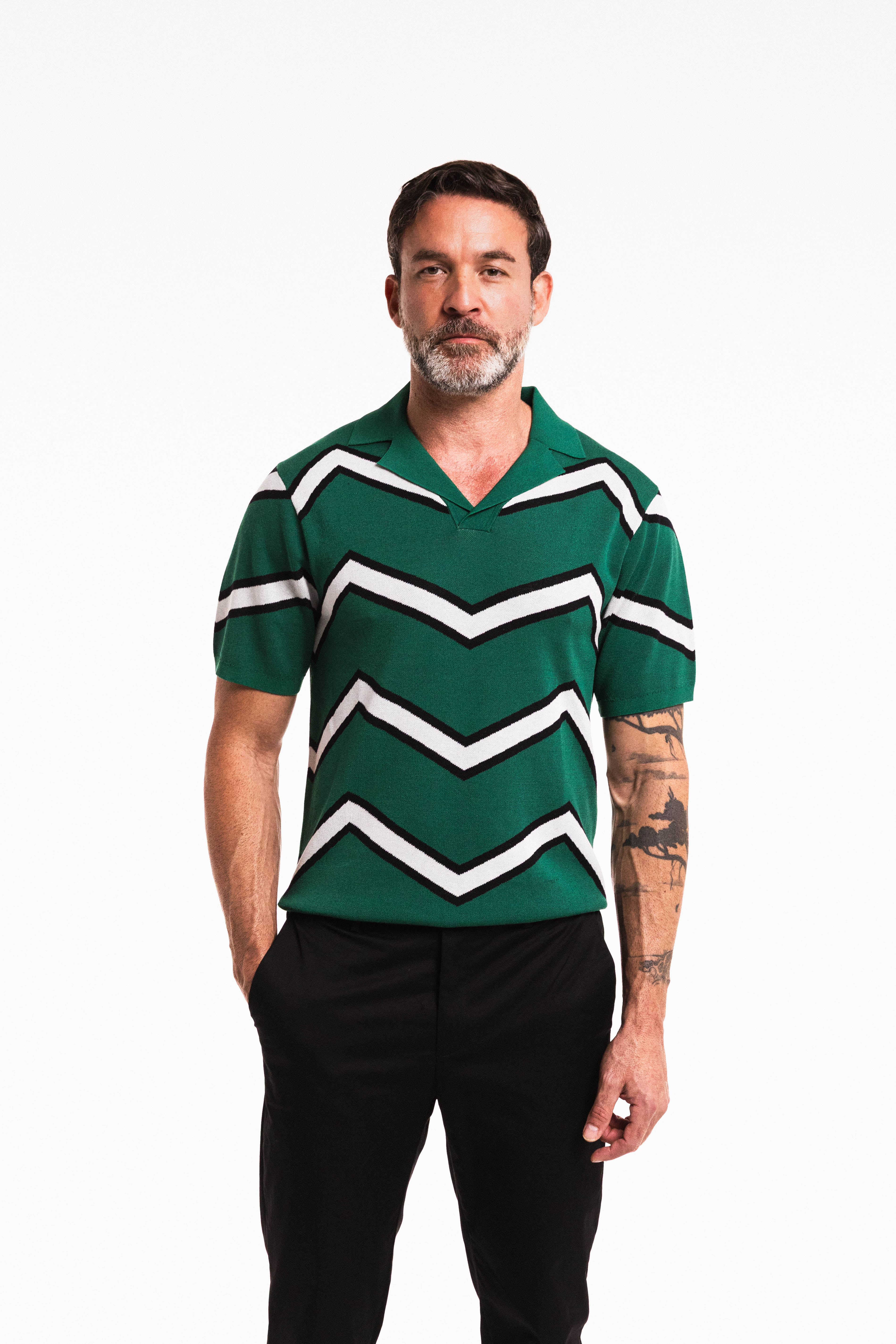 Model wearing Chevron Polo in Forest Green – close up front view standing