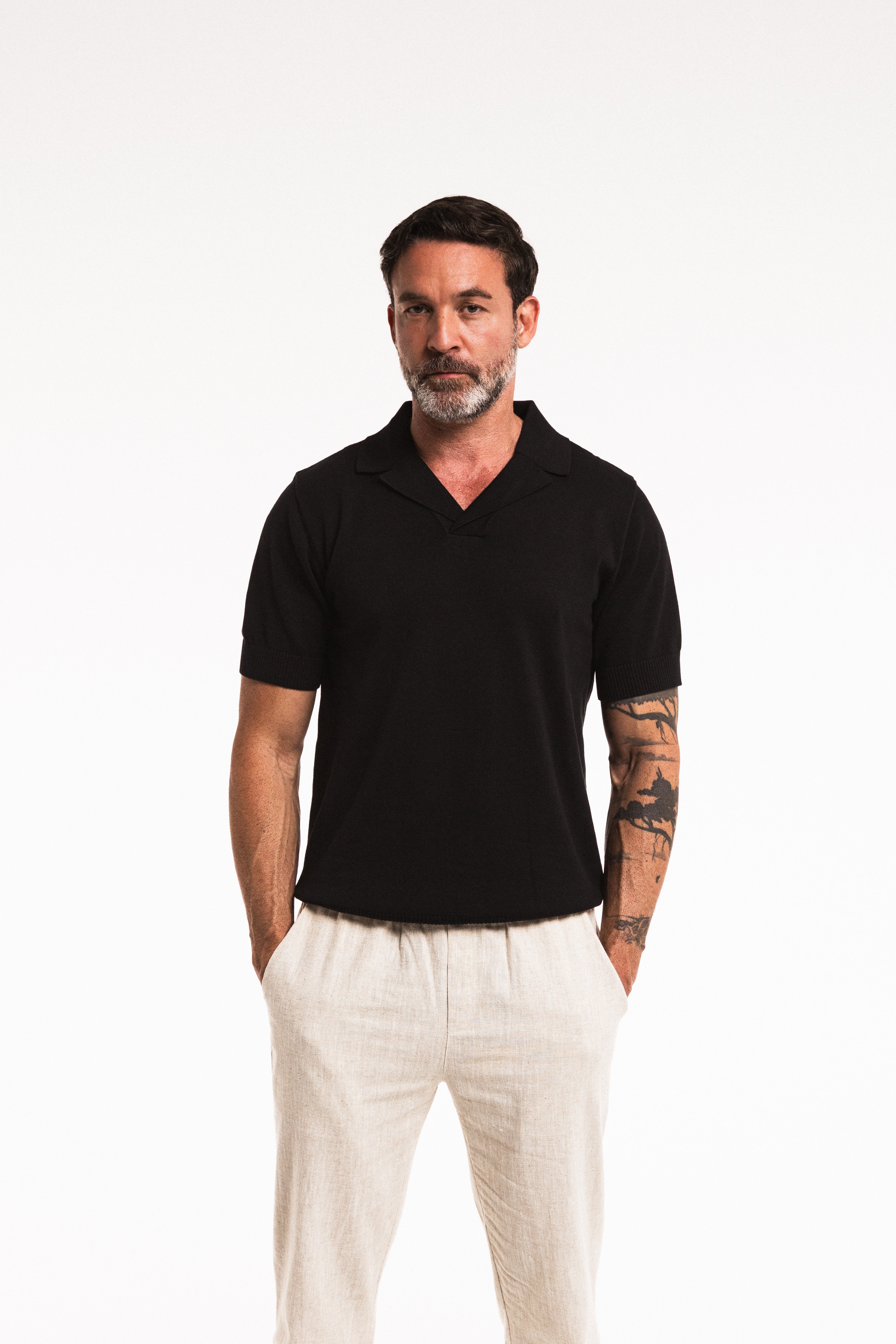 Close-up front view of model wearing Classic Polo in Obsidian – ribbed collar and knit detail